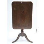 A 19th century mahogany tripod table with rounded corners to the rectangular tilt-top, & on vase-