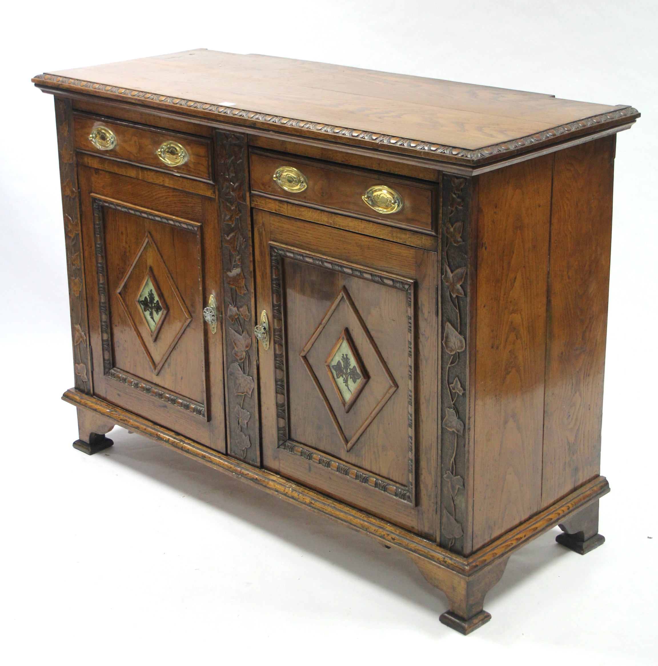 A late 19th/early 20th century carved oak sideboard base (lacking mirror back) fitted two frieze