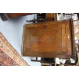 A late 18th century inlaid oak hanging corner cupboard fitted three shaped shelves enclosed by a
