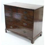 A 19th century mahogany low chest, fitted brushing slide above two short & three long graduated