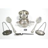 A pair of silver decanter labels “Madeira” & “Port”; a silver tea strainer & bowl; & three various