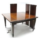 An Edwardian mahogany extending dining table with moulded edge & round corners to the rectangular
