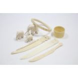 A carved ivory bangle with dragon design; three ivory knives; three ivory elephant ornaments; & an