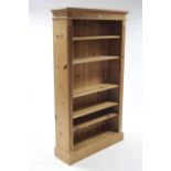 A pine tall standing open bookcase with five adjustable shelves &on plinth base, 37¾” wide x 66”