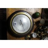 A modern aneroid wall barometer; a brass postal scale; a brass table lamp; a modern standard lamp; &