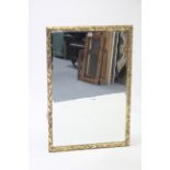 A large gilt frame rectangular wall mirror with raised foliate border & inset bevelled plate, 37”
