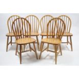 A set of six Windsor-style dining chairs with spindles to the hooped backs, hard seats & on round