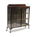 An Edwardian mahogany bow-front china display cabinet fitted two shelves enclosed by pair of