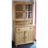 A continental-style reclaimed pine small dresser the upper part fitted two shelves enclosed by