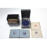 A portable gramophone in black fibre-covered case; & approximately forty various records.