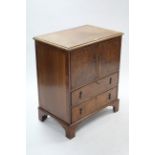 A burr-walnut small cabinet enclosed by pair of panel doors above two long drawers, & on bracket
