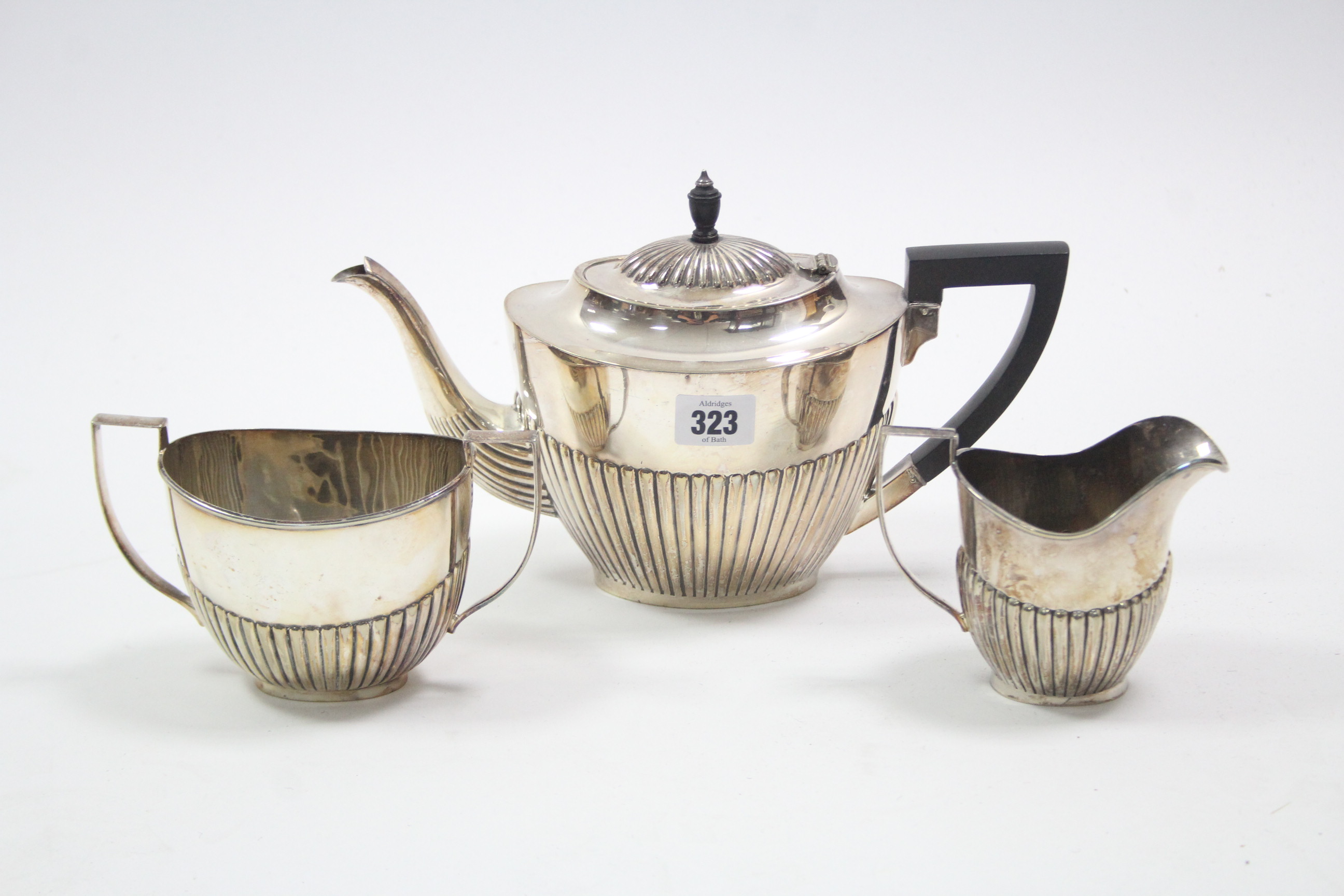 An EPNS three-piece tea service of oval semi-fluted design.