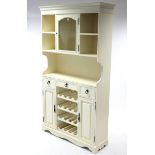 A cream-finish wooden tall kitchen cabinet fitted with an arrangement of cupboards, drawers,