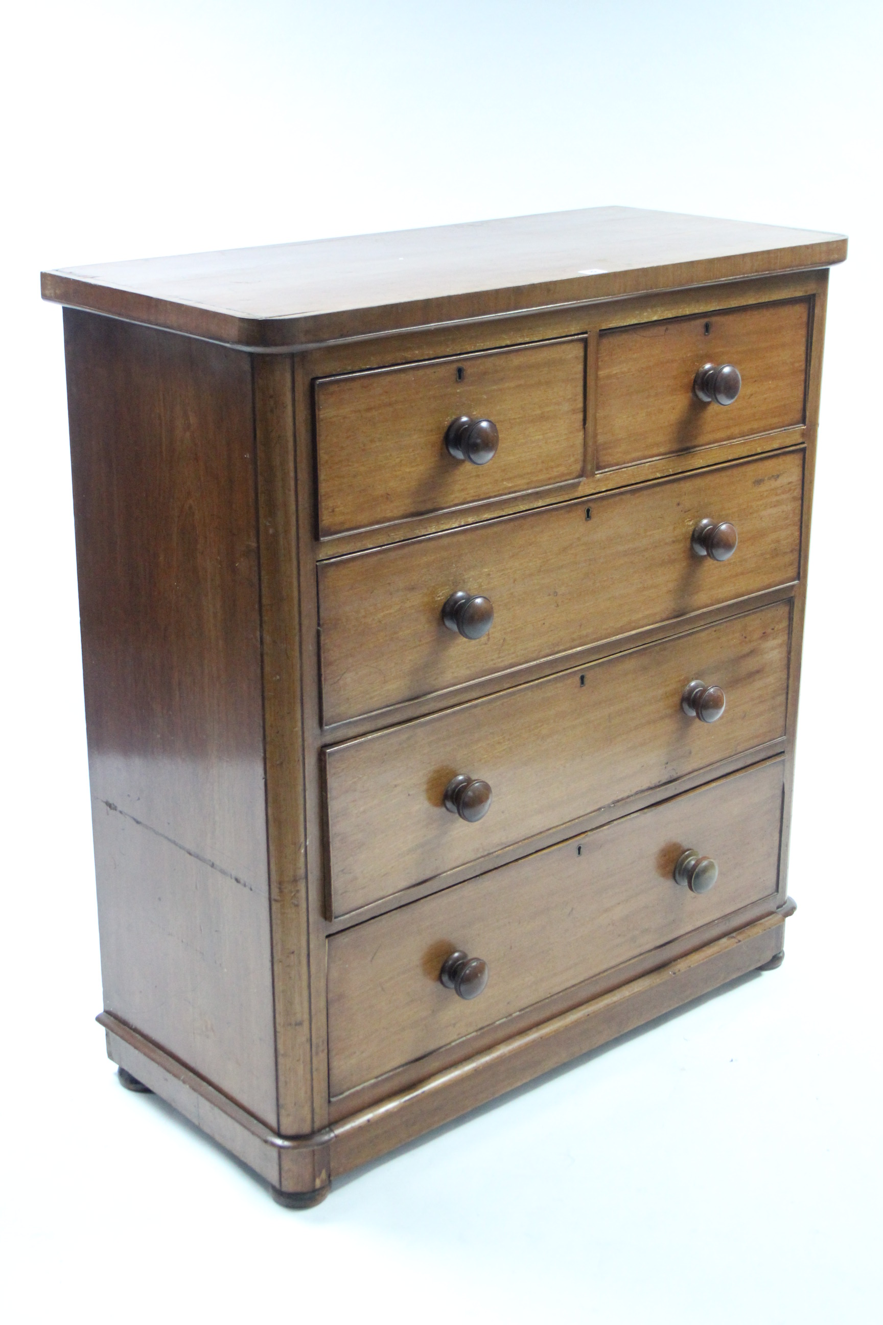 A Victorian mahogany small chest fitted two short three long graduated drawers with turned knob