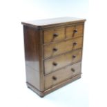 A Victorian mahogany small chest fitted two short three long graduated drawers with turned knob