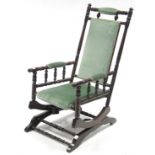 A late 19th/early 20th century beech frame rocking chair on sprung base.