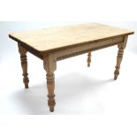 A pine kitchen table with rounded corners to the rectangular top, & on four turned legs, 60” x 31½”;