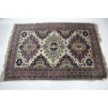 A Persian pattern small carpet of ivory ground & with multi-coloured geometric design to centre