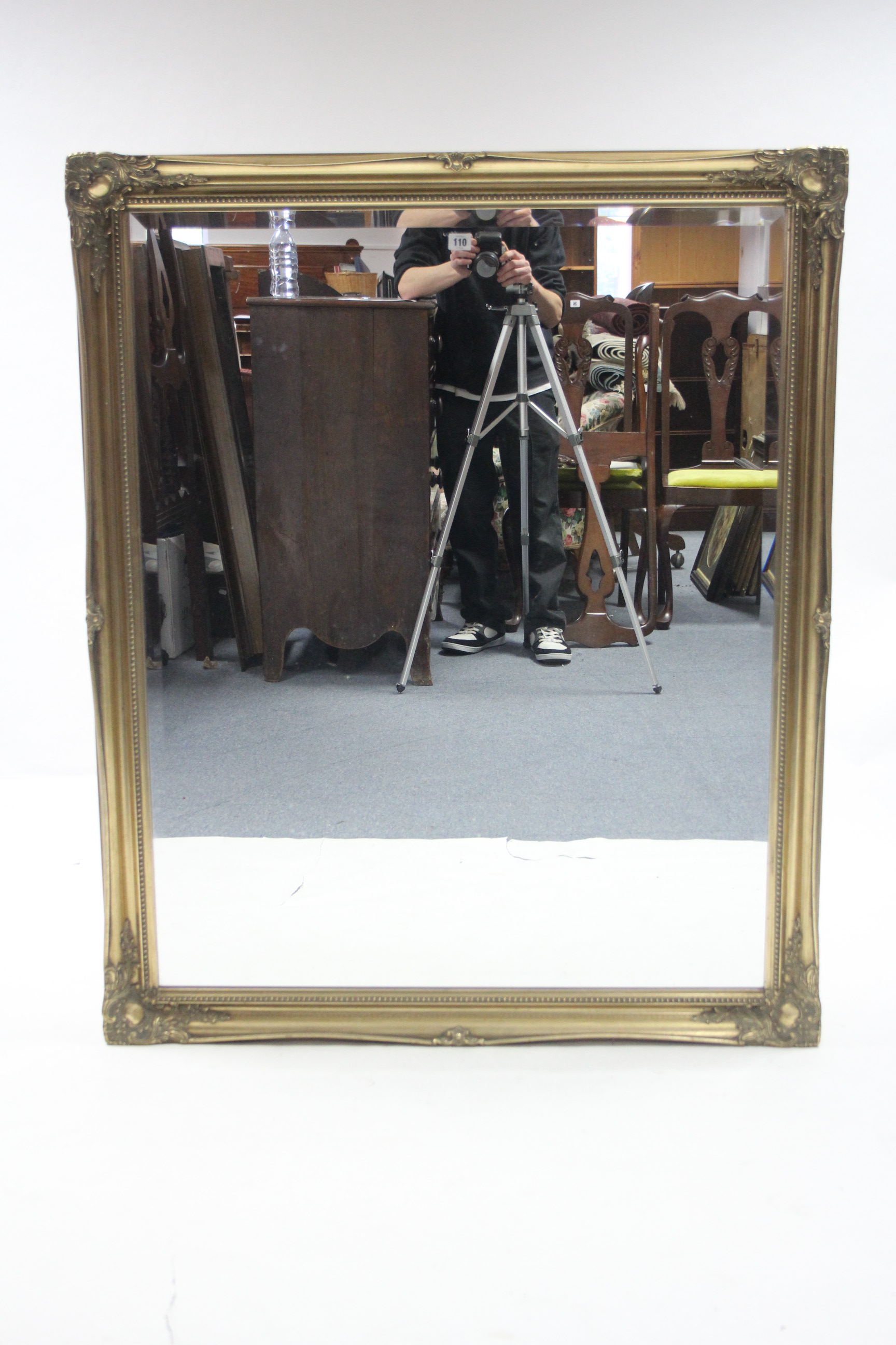 A large gilt-frame rectangular wall mirror with raised foliate border & inset bevelled plate, 51”