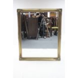 A large gilt-frame rectangular wall mirror with raised foliate border & inset bevelled plate, 51”