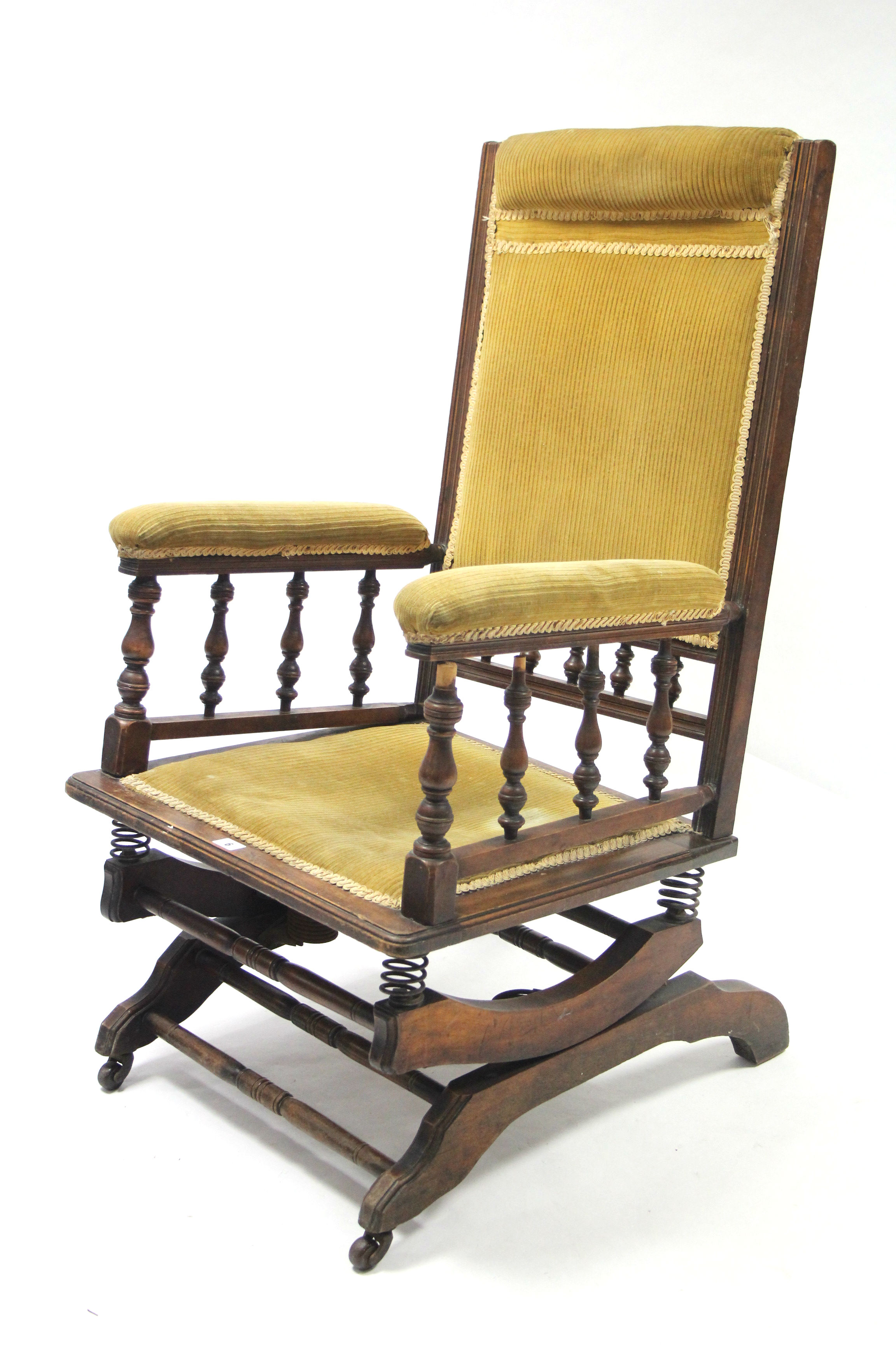 A late 19th/early 20th century beech rocking chair on sprung base, slight faults.