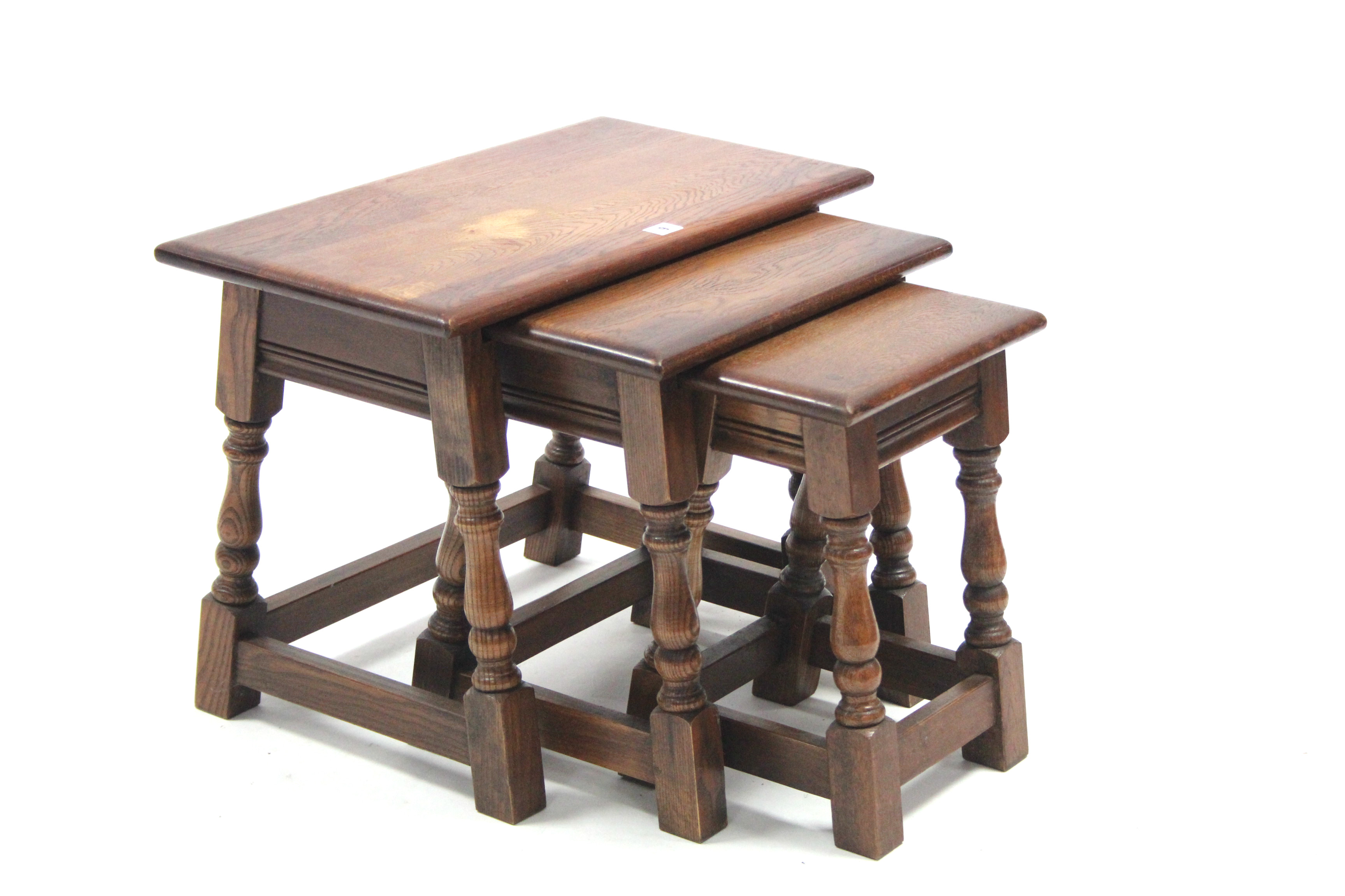 An oak nest of three rectangular occasional tables each table on four baluster-turned legs with