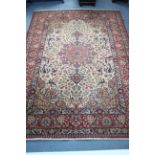 A Persian pattern carpet of cream & crimson ground, & with all-over repeating multi-coloured