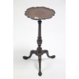 A late 19th/early 20th century mahogany tripod table with moulded pie-crust edge to the circular