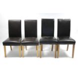 A pair of black leather dining chairs on square tapered legs; & a similar pair of brown leather