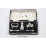 A silver three-piece condiment set, cased, Sheffield 1963.