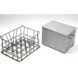 A silvered-metal coal box; a steel twenty-division milk crate; & two modern rugs.