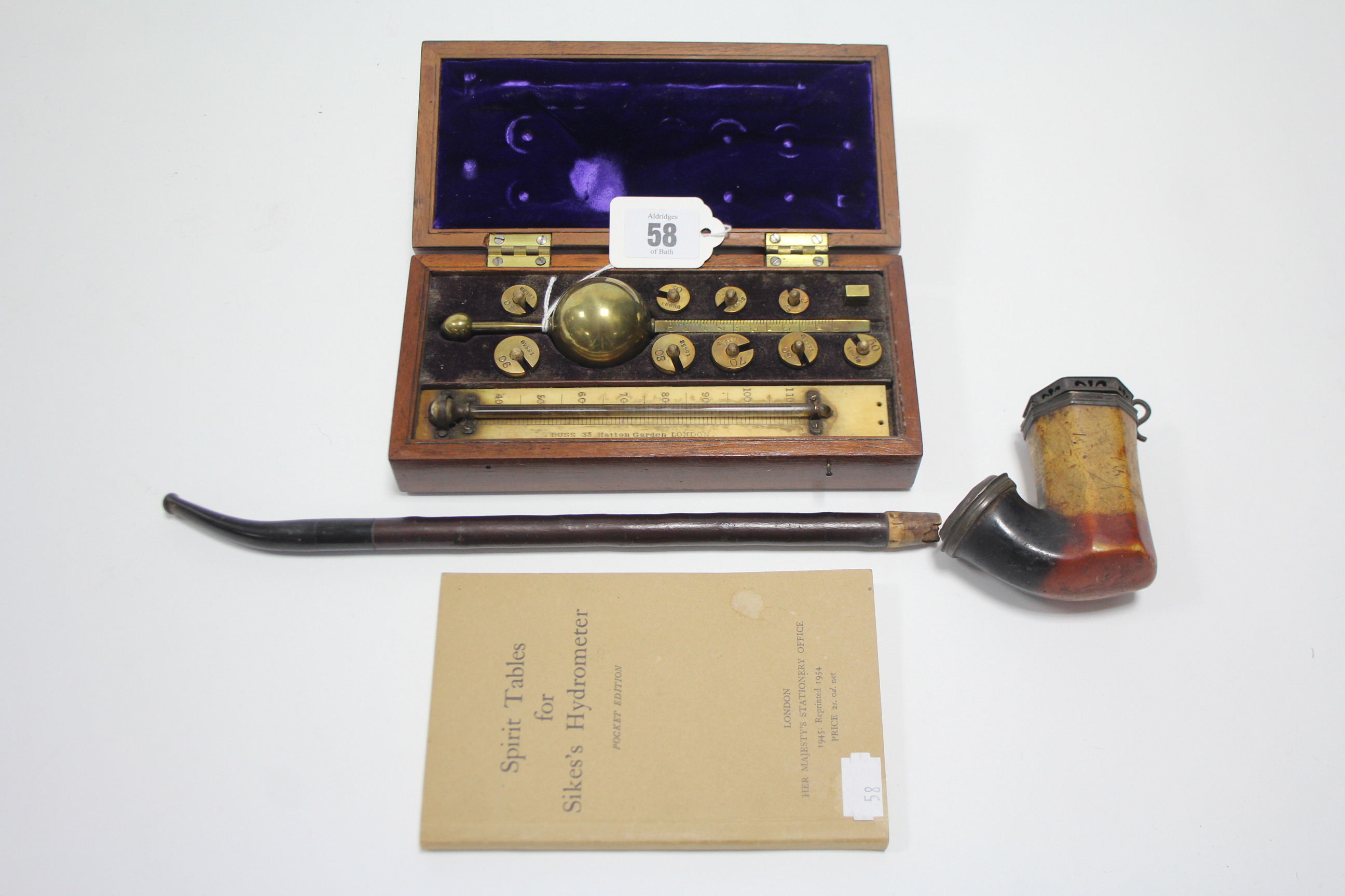 A BUSS of London brass hydrometer in mahogany case; one volume “Spirit Tables for Sike’s