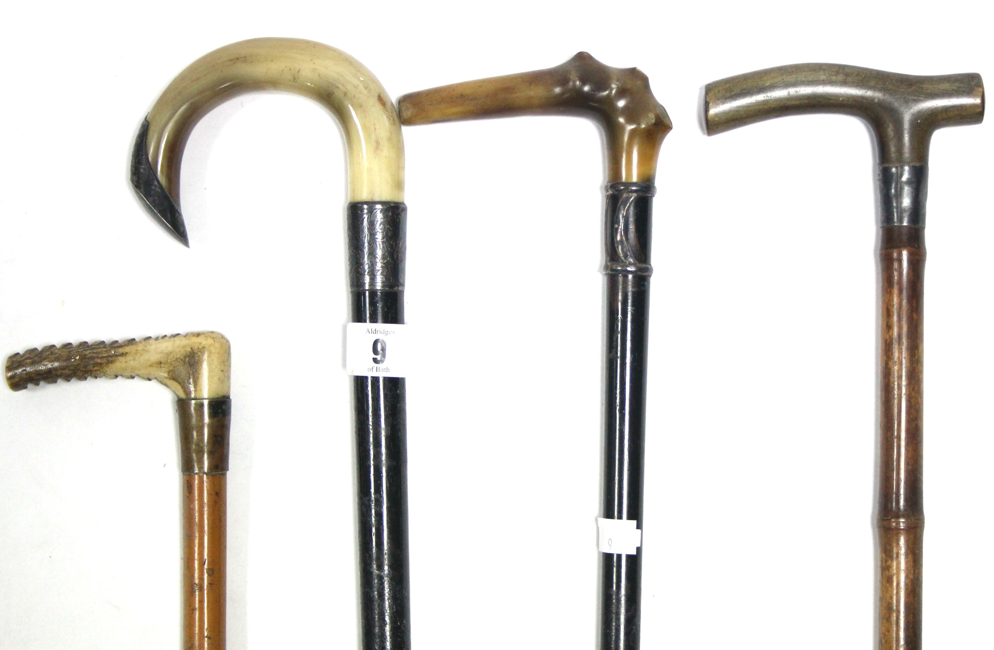 Four various late 19th/early 20th century gents walking sticks each with silver mount, and with horn