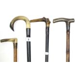 Four various late 19th/early 20th century gents walking sticks each with silver mount, and with horn