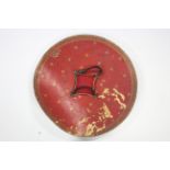 An eastern leather circular shield with four metal bosses & a hair-tuft to the centre; 26" diam.