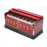 A Bina portable harmonium in red & ebonised-finish case, 23½” wide