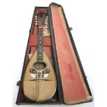 An Italian mandolin, bears label “Torielli Galliano, Napoli”, 23” long, with case.