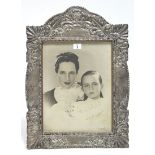 A .900 standard silver large rectangular photograph frame with embossed scroll border, insert