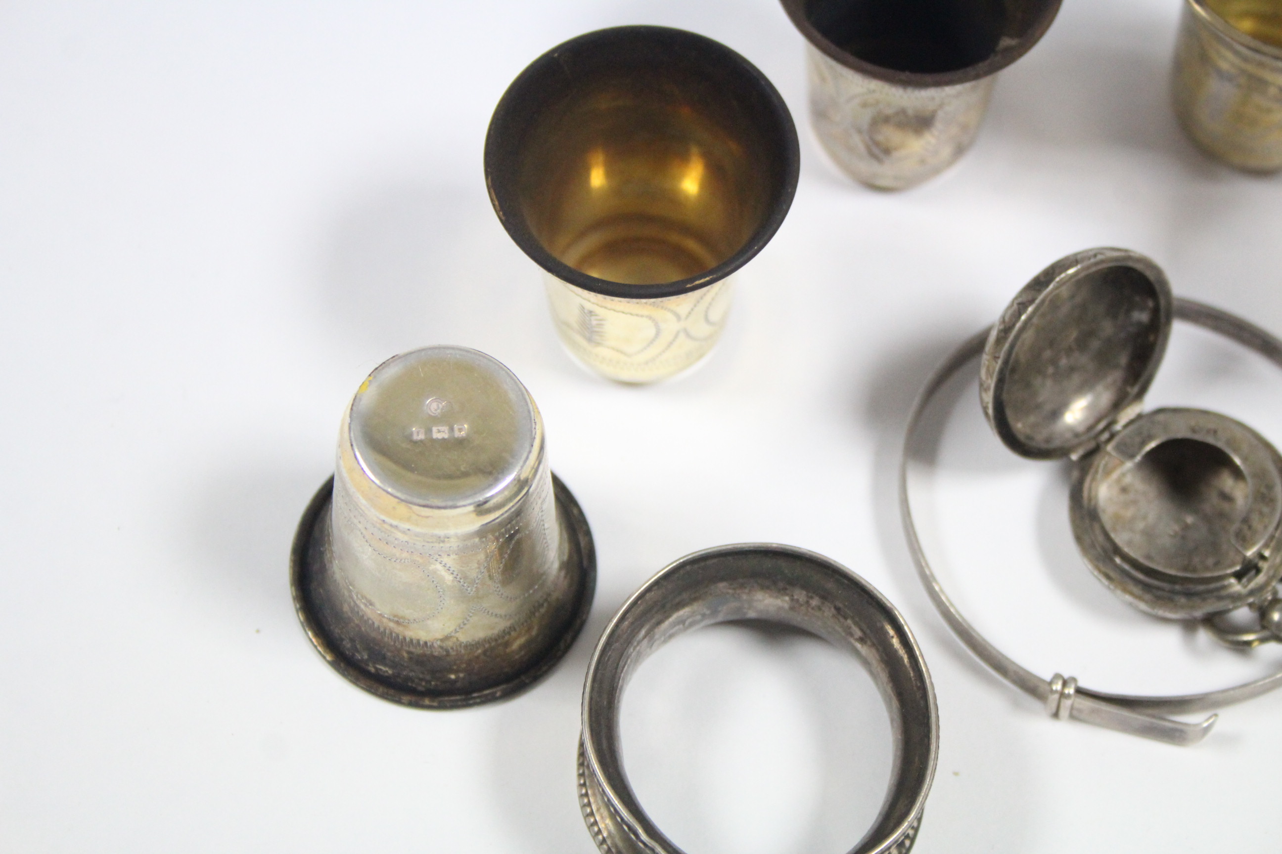 A set of six George V silver engraved shot cups, London 1921; a silver sovereign case; a silver - Image 2 of 2