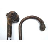 A walking cane with carved dogs-head handle; together with another walking cane; a modern Chinese