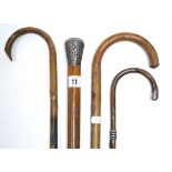 A late 19th/early 20th century gents walking cane with silver embossed handle (hallmarks rubbed)