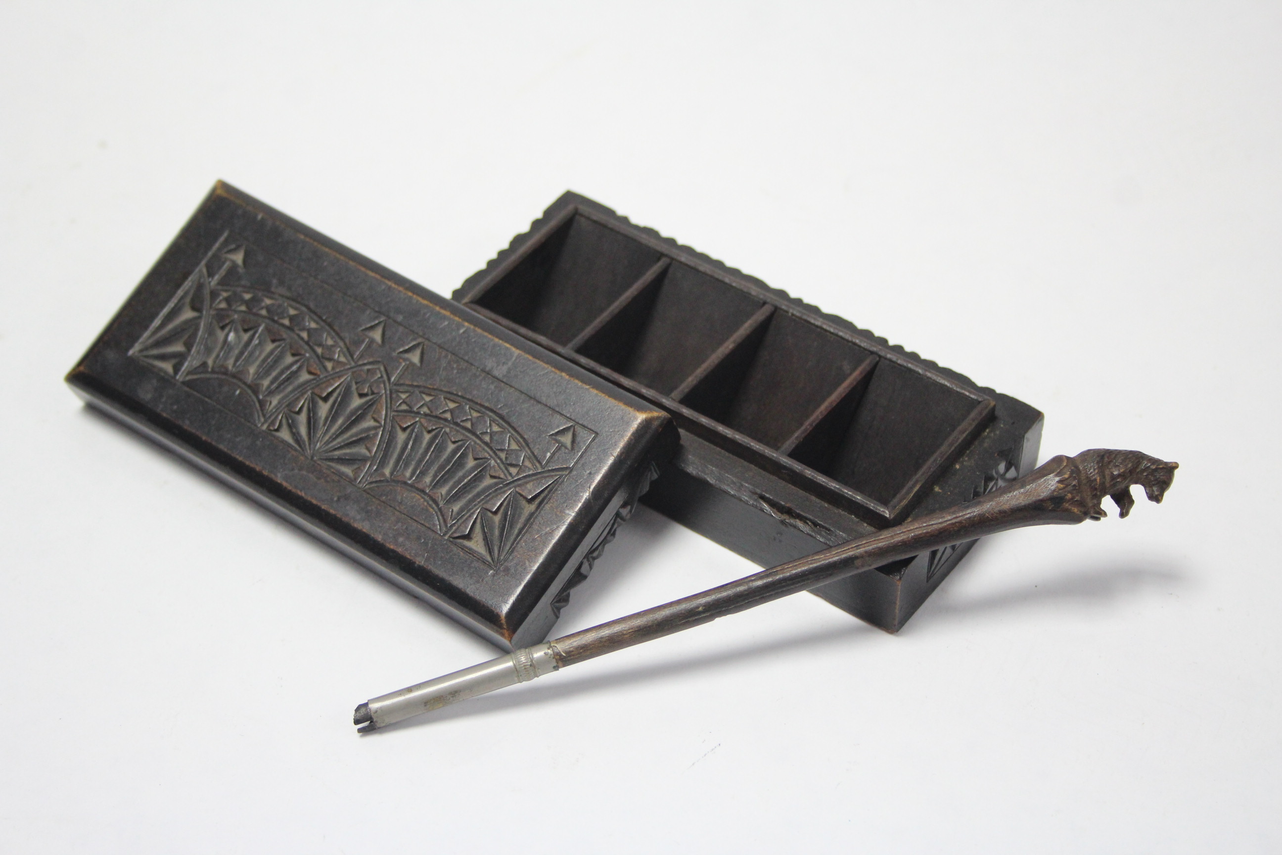 A carved & ebonised wooden four-division stamp box, 4¾” wide; & a Bavarian wooden pen with carved