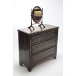A mid 20th century low oak chest fitted three long graduated drawers with brass swan-neck handles,
