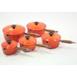 A set of five Le Creuset orange enamelled graduated saucepans, 5¼" - 8¼" diam.