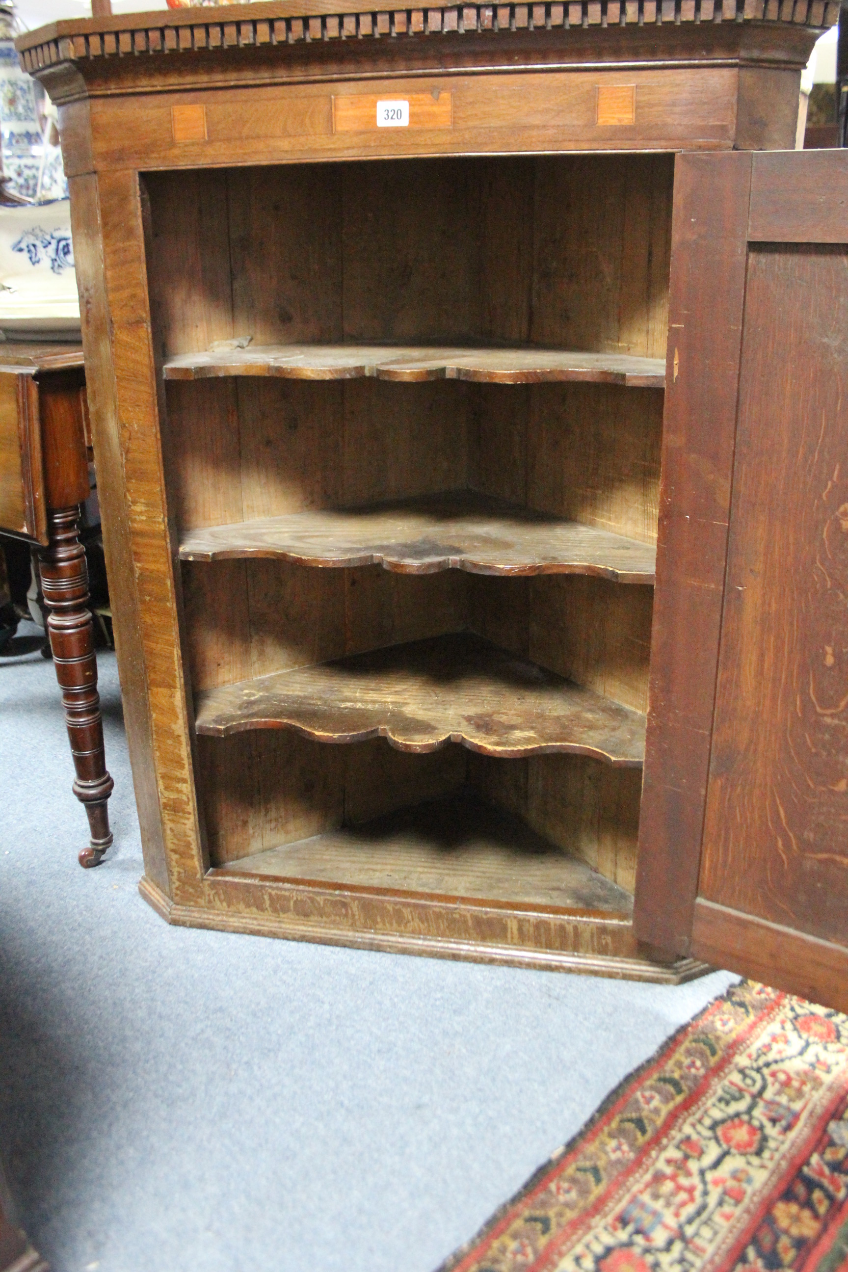 A late 18th century inlaid oak hanging corner cupboard fitted three shaped shelves enclosed by a - Image 2 of 2