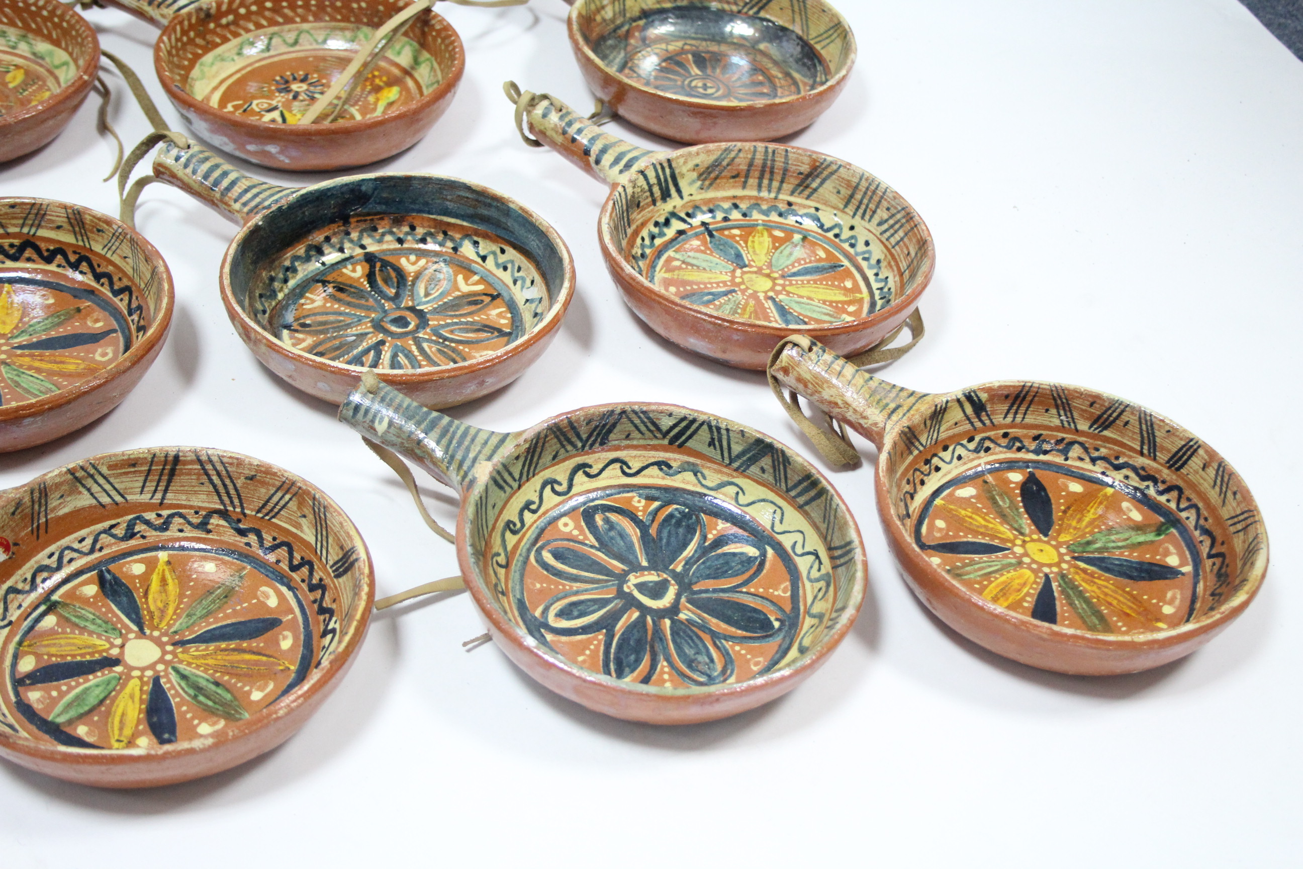 A set of twelve Mexican pottery cooking pans, each with bright-coloured geometric design; a ditto - Image 4 of 10