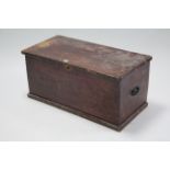 A deal storage trunk with hinged lift-lid & wrought-iron side handles, 33” wide.
