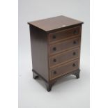 A reproduction inlaid-mahogany small chest, fitted four long graduated drawers with brass ring