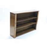 An oak & mahogany standing open bookcase with two adjustable shelves, 55¼” wide x 38” high.