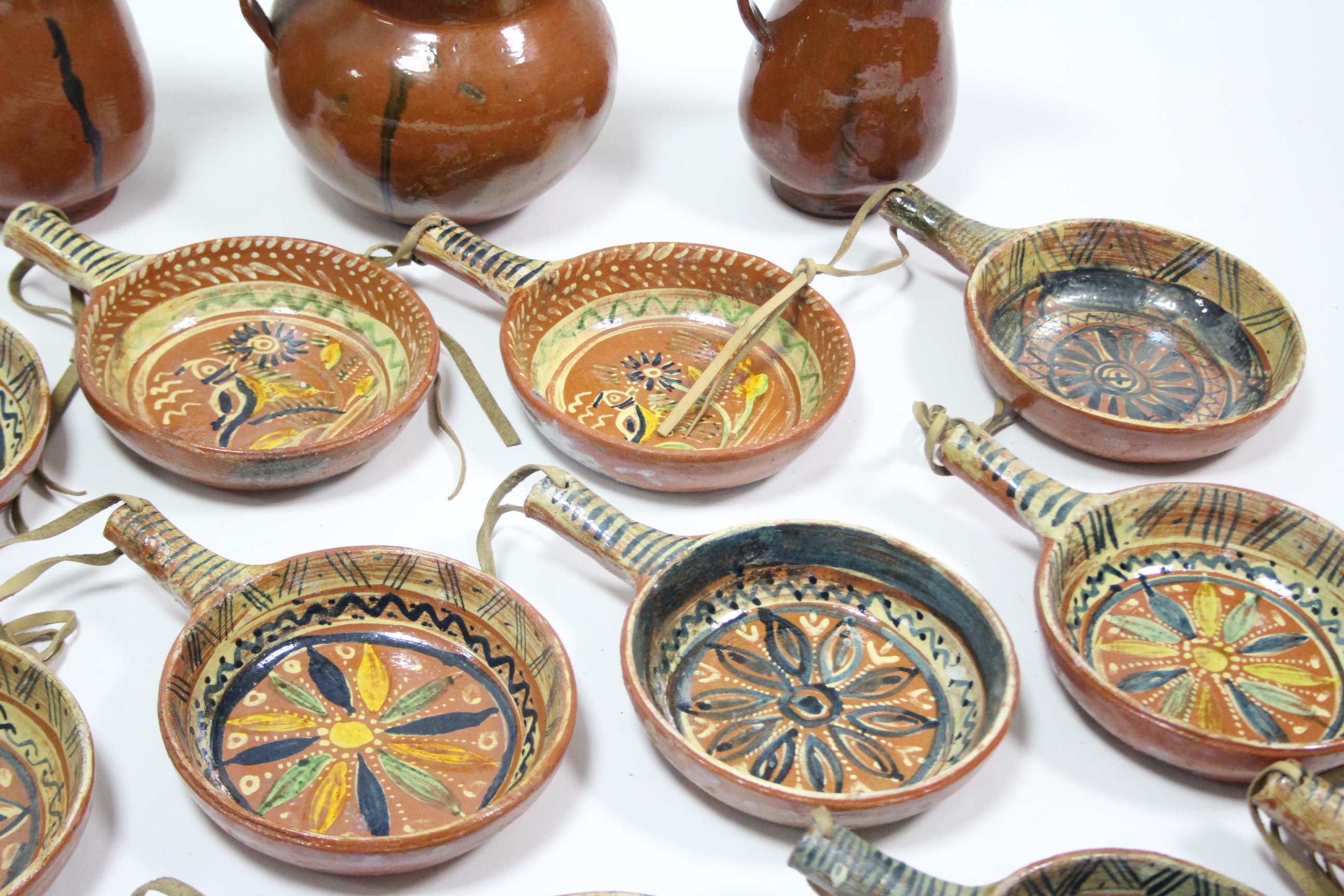 A set of twelve Mexican pottery cooking pans, each with bright-coloured geometric design; a ditto - Image 5 of 10